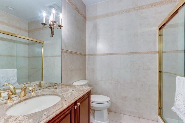 full bathroom featuring vanity, a tile shower, tile walls, toilet, and tile patterned floors