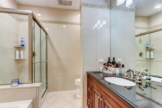 bathroom featuring visible vents, toilet, tile walls, a shower stall, and tile patterned flooring