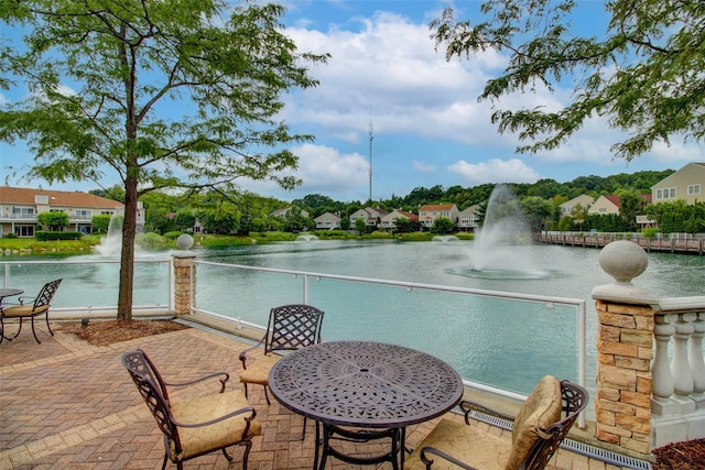 view of patio with a residential view, visible vents, and a water view