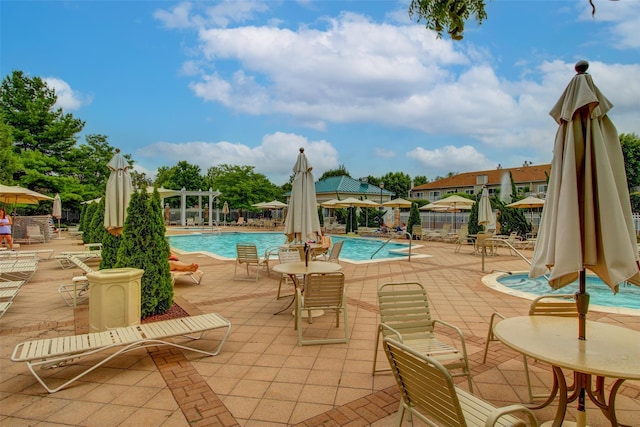 pool with a patio and a pergola