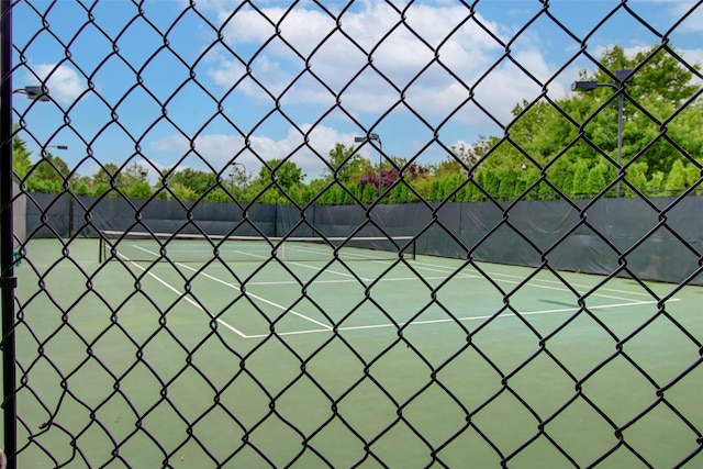 view of sport court featuring fence