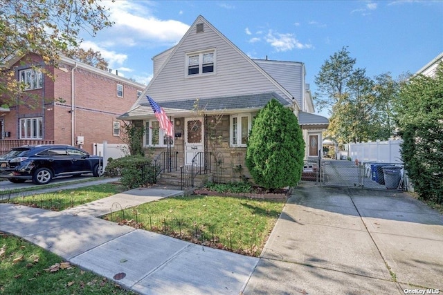 view of front of house with stone siding and fence