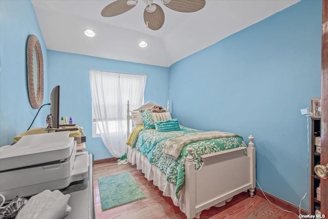 bedroom featuring recessed lighting, baseboards, lofted ceiling, and wood finished floors