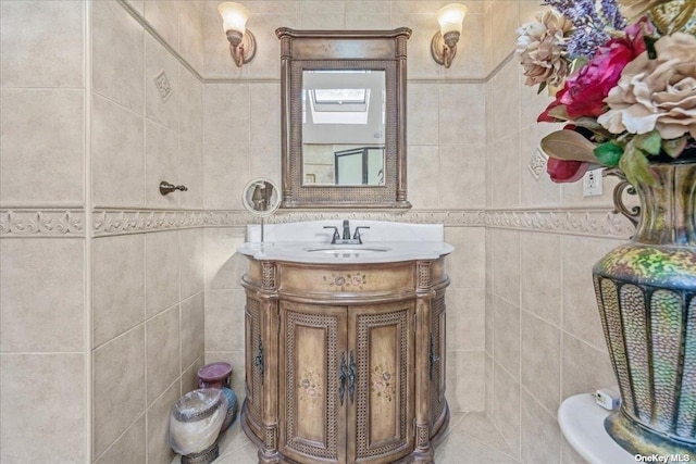 bathroom with vanity, tile walls, and tile patterned floors