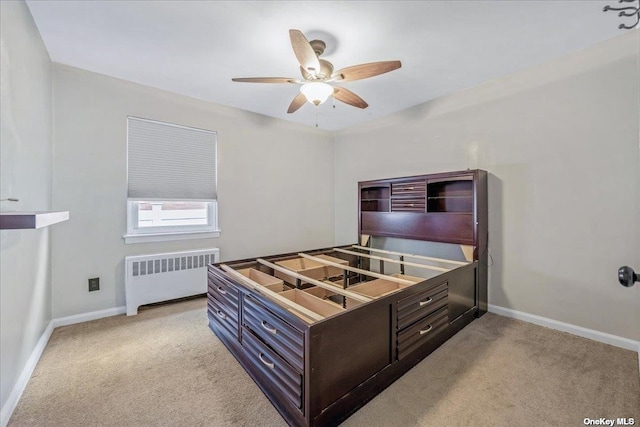 bedroom featuring light colored carpet, radiator heating unit, and baseboards