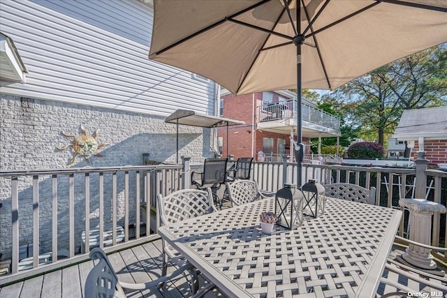 wooden deck featuring outdoor dining area