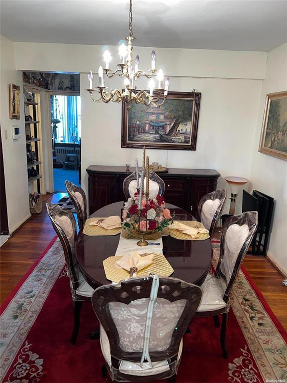 dining room with a notable chandelier and wood finished floors