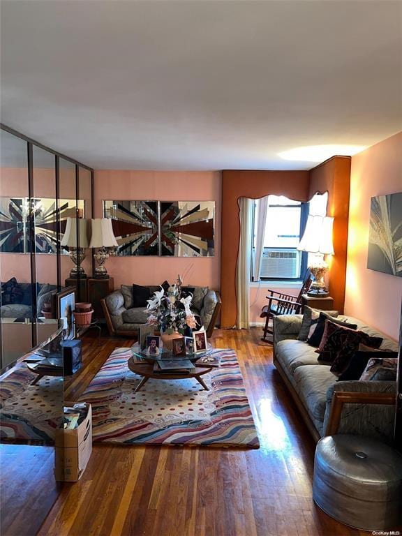 living room featuring cooling unit and hardwood / wood-style floors