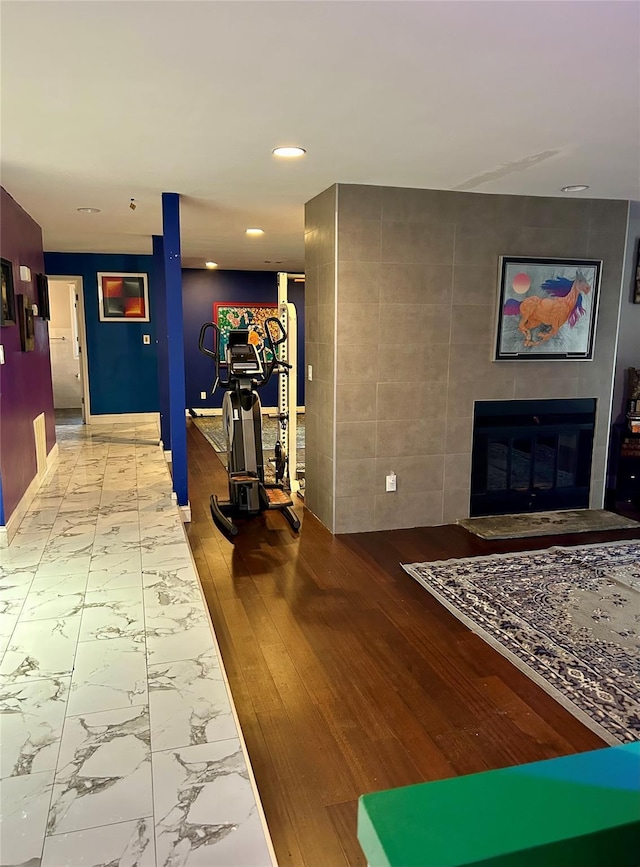 hallway featuring recessed lighting, marble finish floor, and baseboards