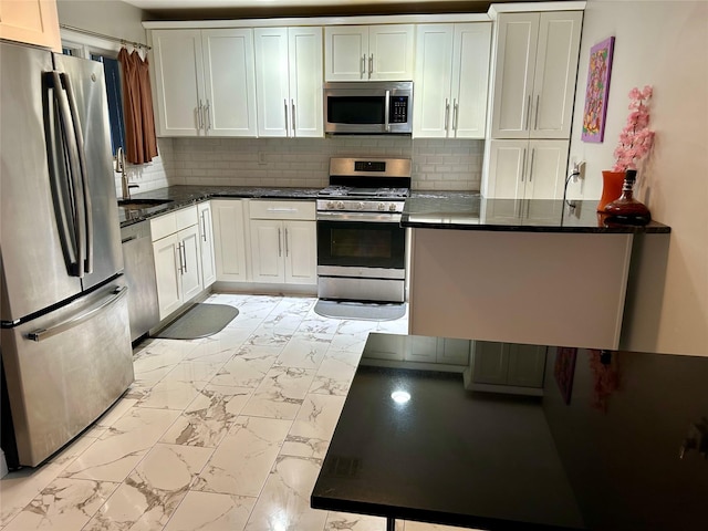 kitchen with backsplash, marble finish floor, appliances with stainless steel finishes, and a sink