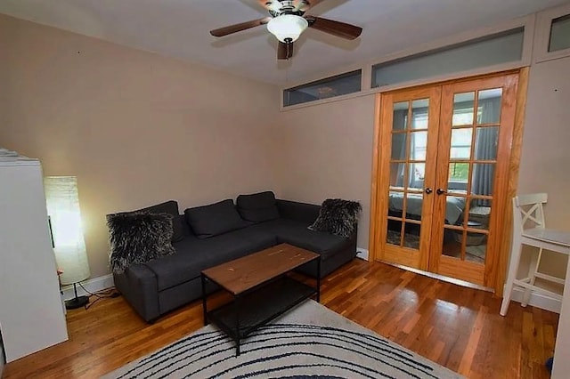 living area featuring french doors, wood finished floors, and a ceiling fan