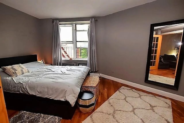 bedroom featuring wood finished floors and baseboards