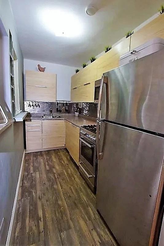 47-37 45th St Unit 2A, Sunnyside, NY 11377 - kitchen with stainless steel appliances, backsplash, and dark wood-style floors