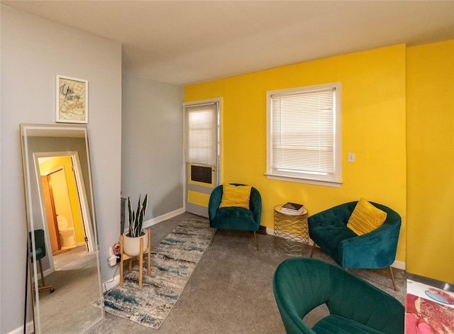 living area with baseboards and carpet flooring