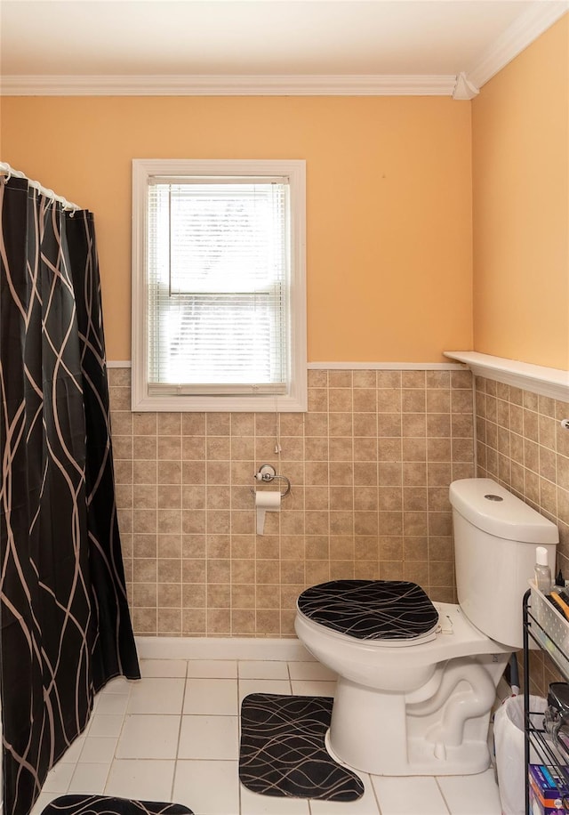 full bath with tile patterned floors, toilet, tile walls, and ornamental molding