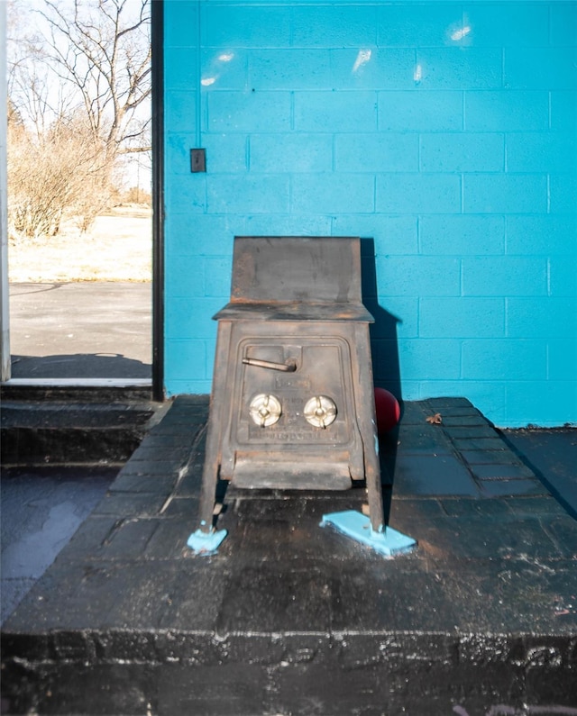 room details with concrete block wall and a wood stove