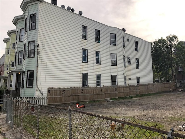 view of side of property featuring fence