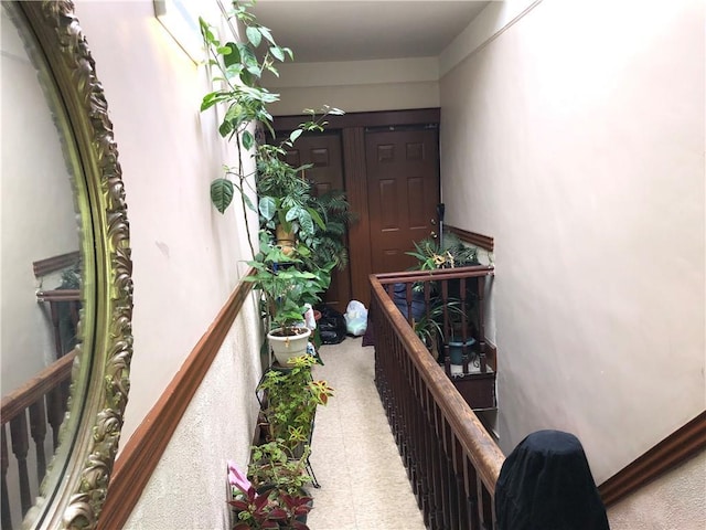 hallway with tile patterned floors