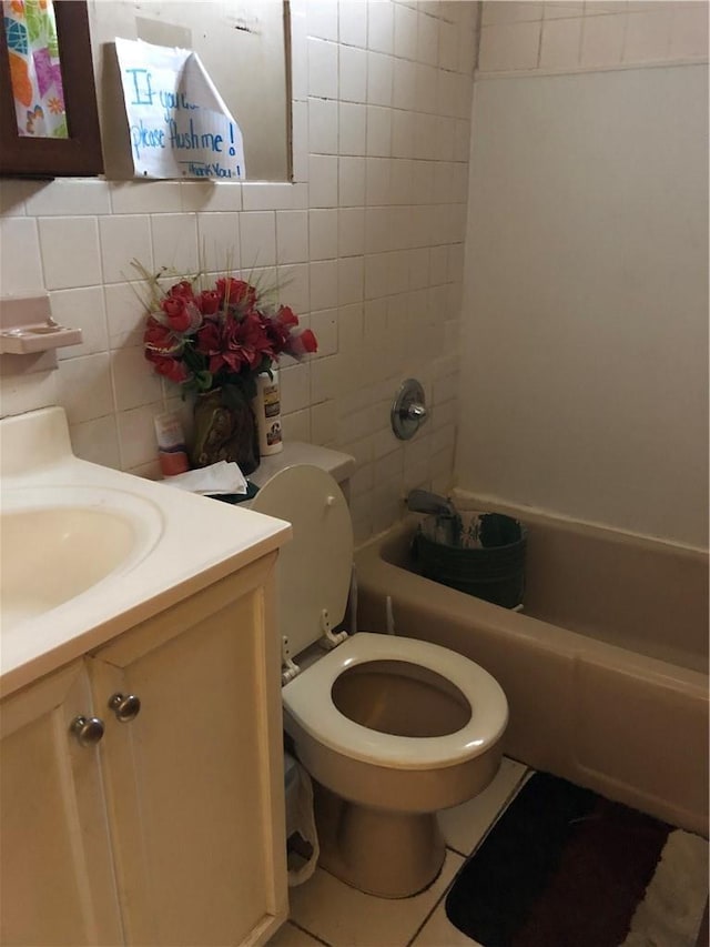 bathroom with toilet, backsplash, tile walls, tub / shower combination, and vanity