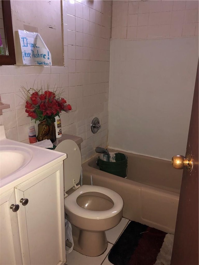 bathroom with tub / shower combination, toilet, tile walls, and vanity