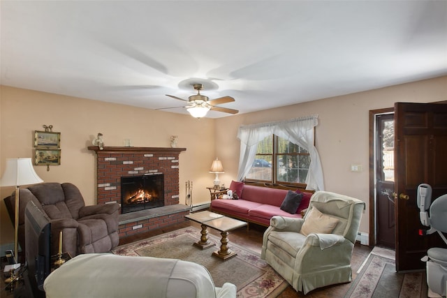 living area featuring a ceiling fan, dark wood finished floors, a fireplace, a baseboard radiator, and baseboard heating