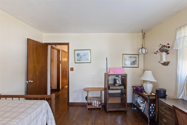 bedroom featuring hardwood / wood-style flooring and baseboards