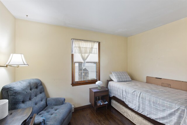 bedroom featuring baseboards and wood finished floors