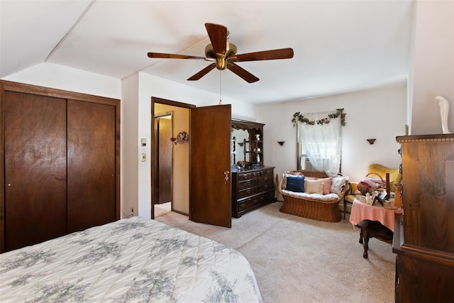 bedroom with light carpet, a closet, ceiling fan, and vaulted ceiling