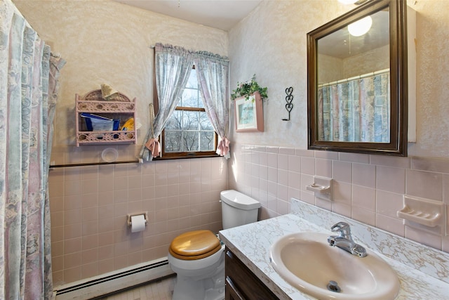 full bathroom with toilet, tile walls, wainscoting, a baseboard radiator, and vanity