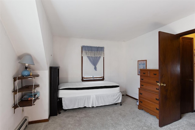 bedroom featuring a baseboard heating unit, baseboards, and carpet flooring