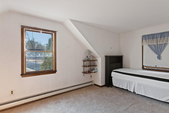 unfurnished bedroom featuring a baseboard heating unit, lofted ceiling, and carpet floors