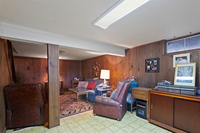 living area with light floors and wood walls