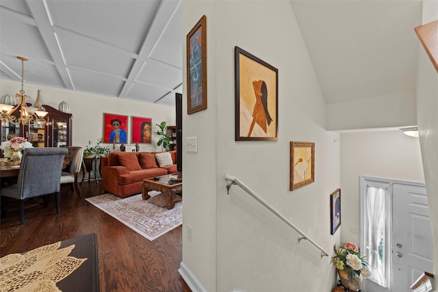 interior space with lofted ceiling, an inviting chandelier, and wood finished floors