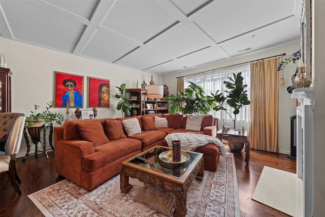 living area with dark wood-style floors, visible vents, and coffered ceiling