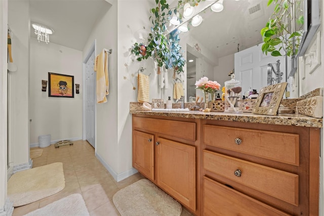 bathroom featuring tile patterned floors, visible vents, baseboards, and vanity