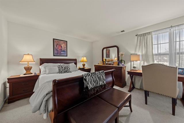 bedroom with visible vents and light colored carpet