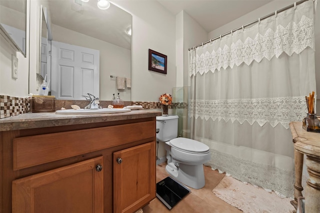 bathroom with tile patterned floors, curtained shower, toilet, and vanity