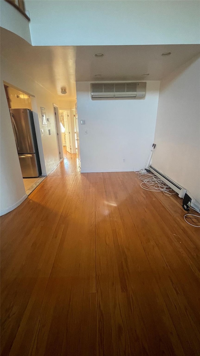 interior space featuring light wood-style flooring and a wall mounted AC