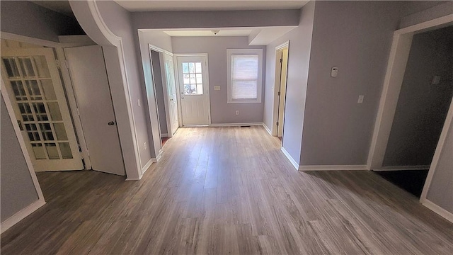 hall featuring wood finished floors and baseboards