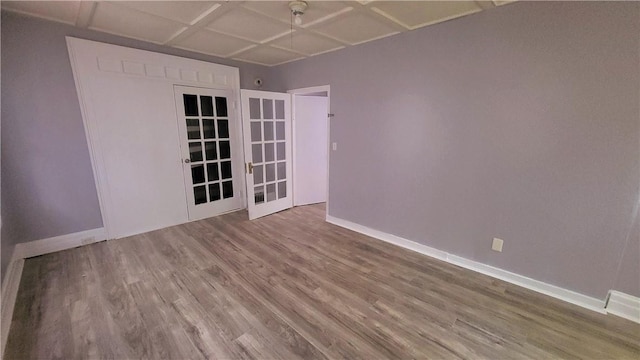 empty room with visible vents, baseboards, and wood finished floors