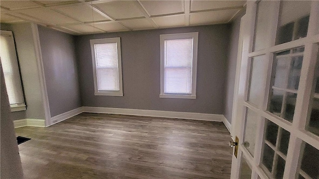 unfurnished room with visible vents, dark wood-style floors, and baseboards