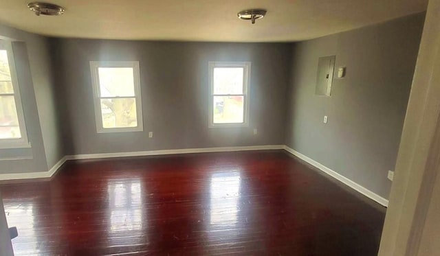 unfurnished room with wood finished floors and baseboards