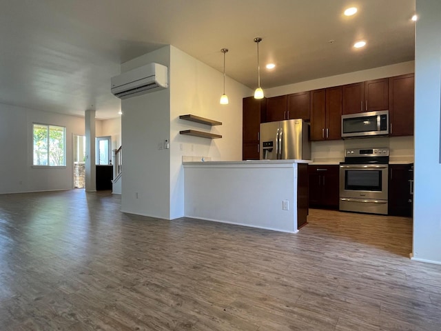 kitchen featuring stainless steel appliances, open floor plan, dark wood-style flooring, and a wall unit AC