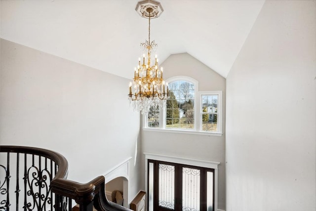 entryway with an inviting chandelier and vaulted ceiling