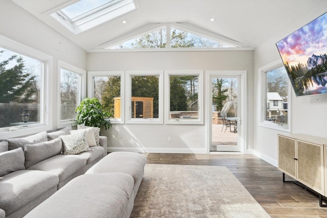 sunroom / solarium featuring lofted ceiling with skylight