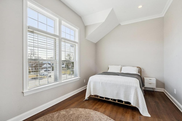 bedroom featuring multiple windows, wood finished floors, and baseboards