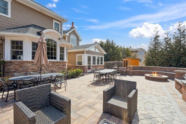 view of patio / terrace featuring outdoor dining space and an outdoor fire pit