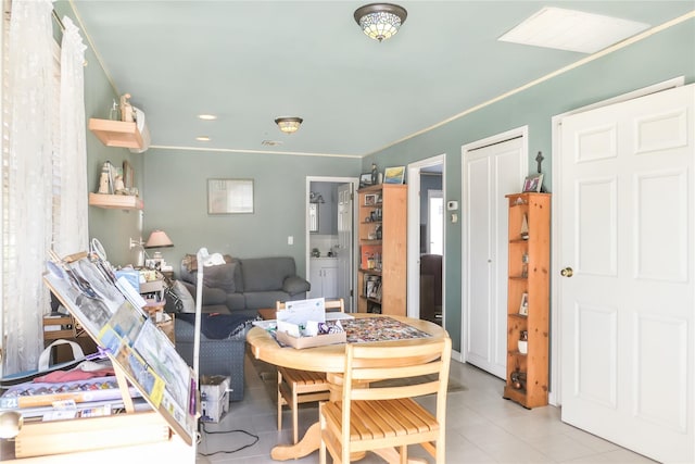 dining area with light tile patterned floors and ornamental molding