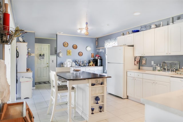 kitchen with white appliances, open shelves, light tile patterned flooring, a sink, and white cabinets