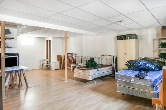 interior space featuring a drop ceiling and wood finished floors